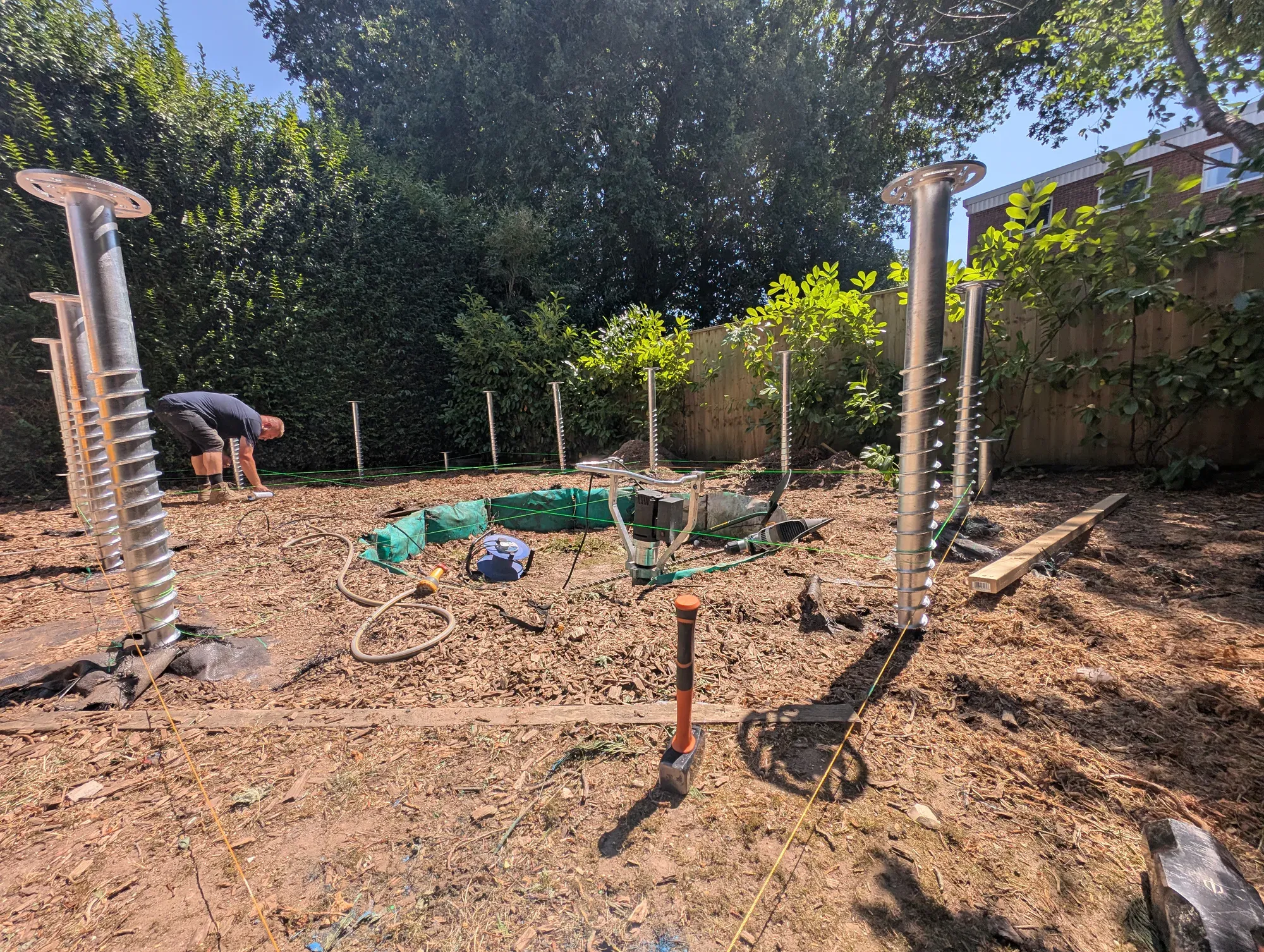 Ground screws set out in pilot positions for a Broadstone garden room