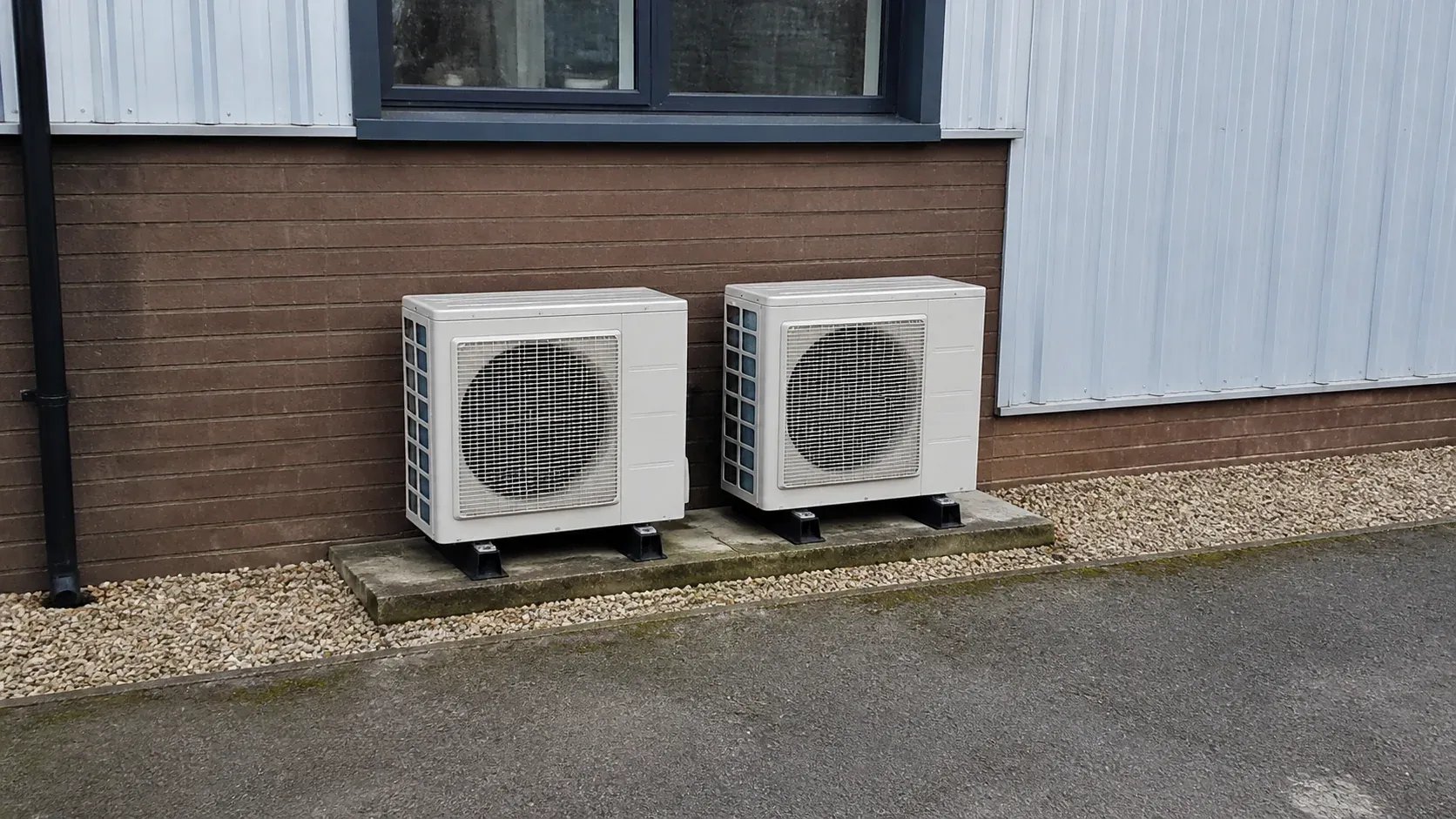 Air conditioning condenser mounted on a tidy outdoor equipment base