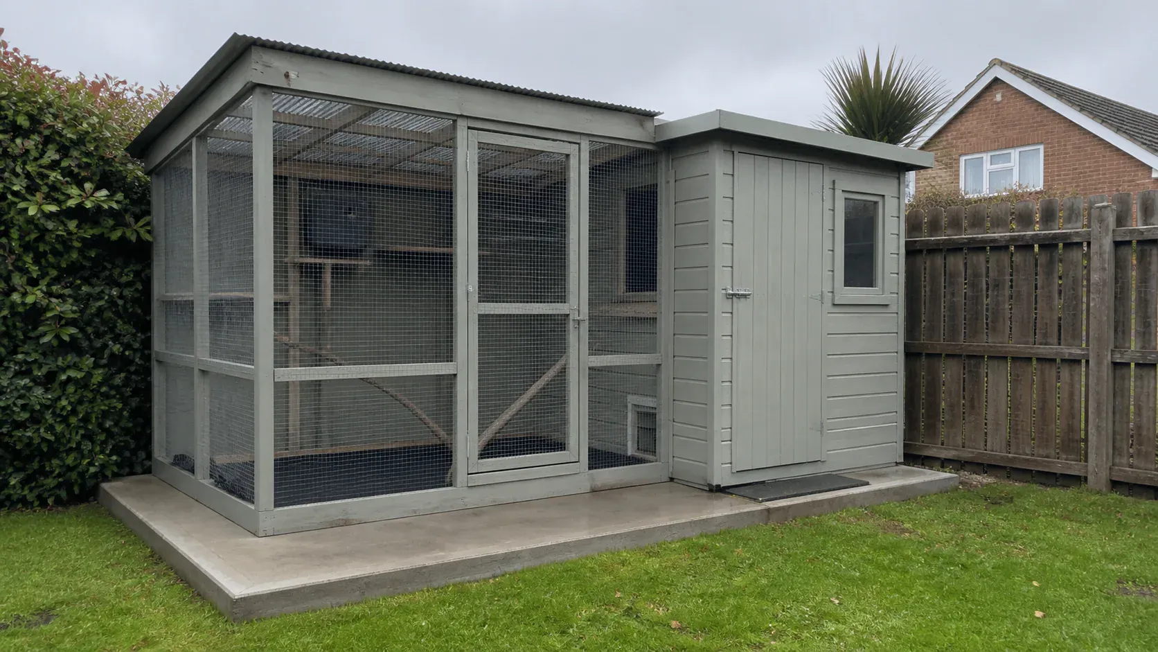 Insulated garden bird room connected to an outdoor aviary