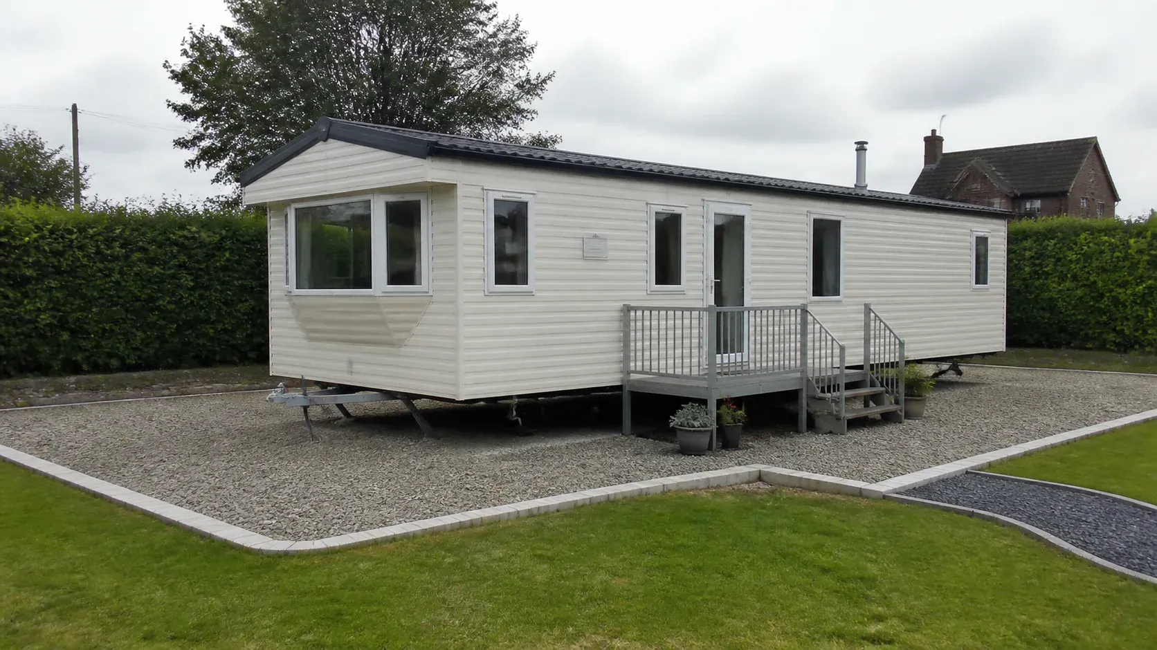 Touring caravan parked level on a neat gravel hardstanding