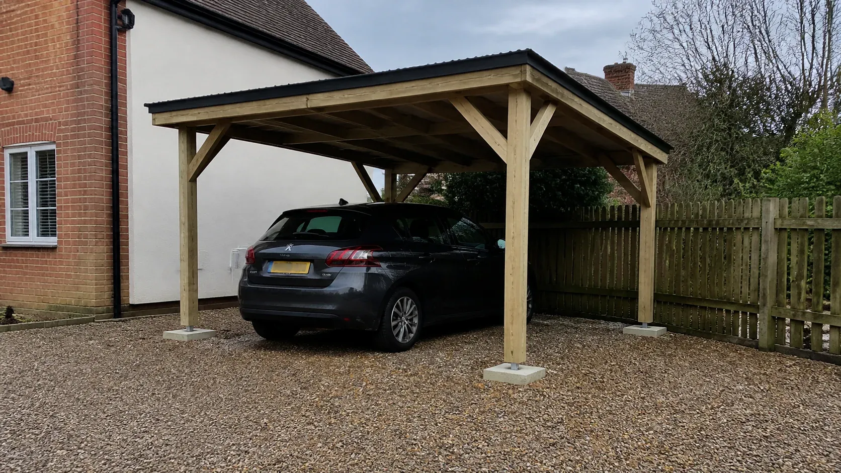 Timber carport beside a home on a clean hardstanding