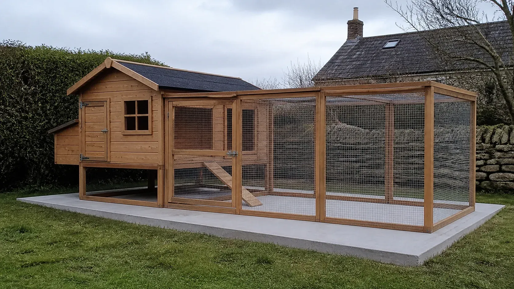 Timber hen house and secure run on a clean garden base
