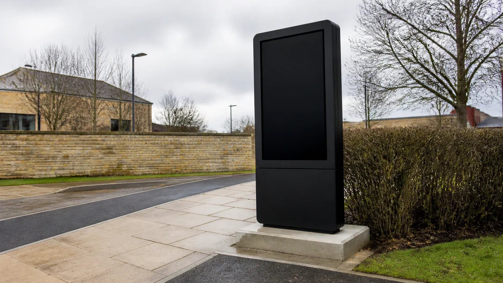 Freestanding digital signage totem fixed to a concrete foundation
