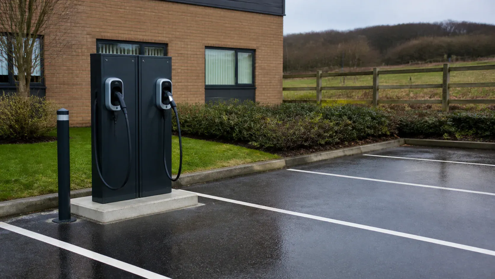 Freestanding electric vehicle charging pedestal on a concrete plinth