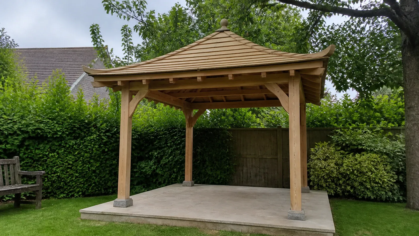 Decorative timber garden pagoda on a paved base