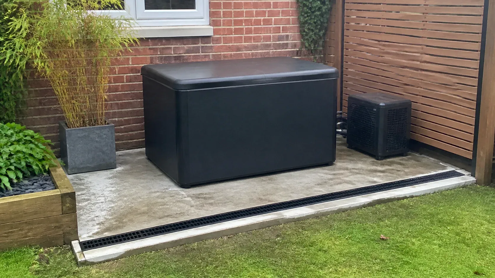 Outdoor cold plunge ice bath on a tidy paved foundation