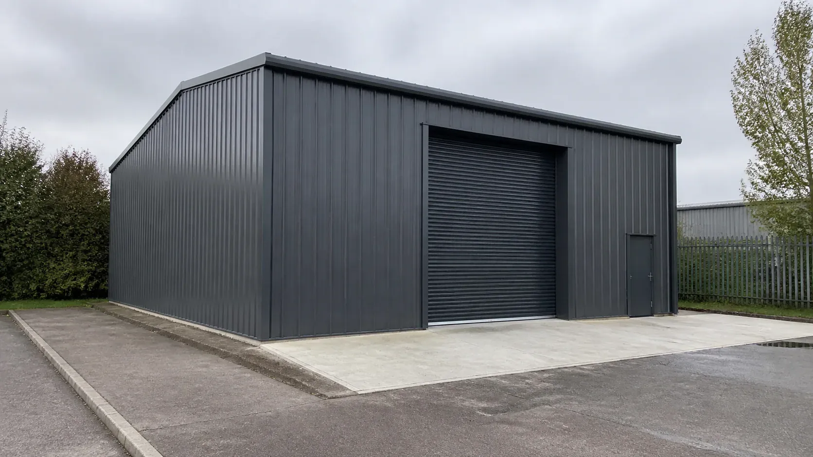 Small modern steel industrial workshop building on a concrete foundation