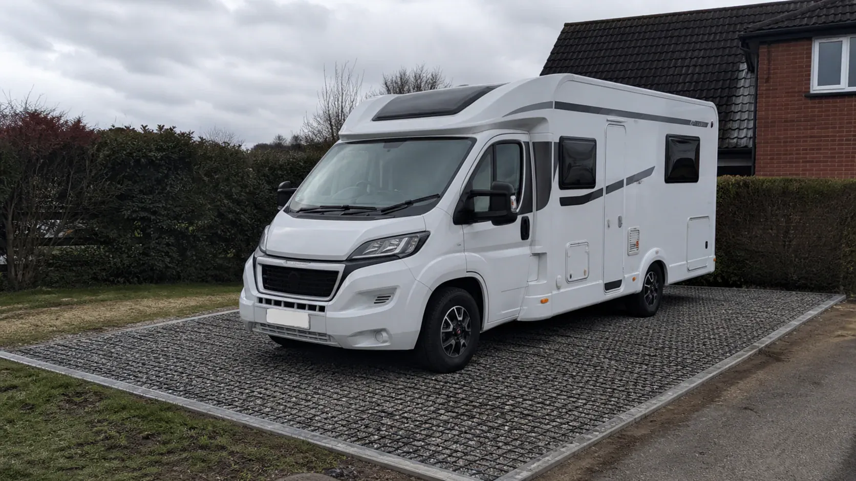 Motorhome parked on a neat permeable driveway hardstanding