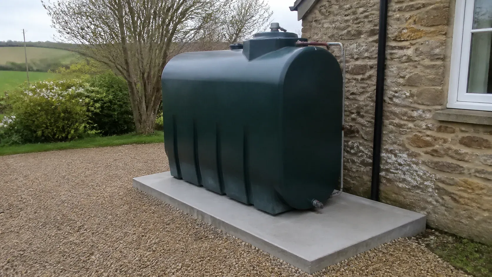 Domestic heating oil tank on a level non-combustible base