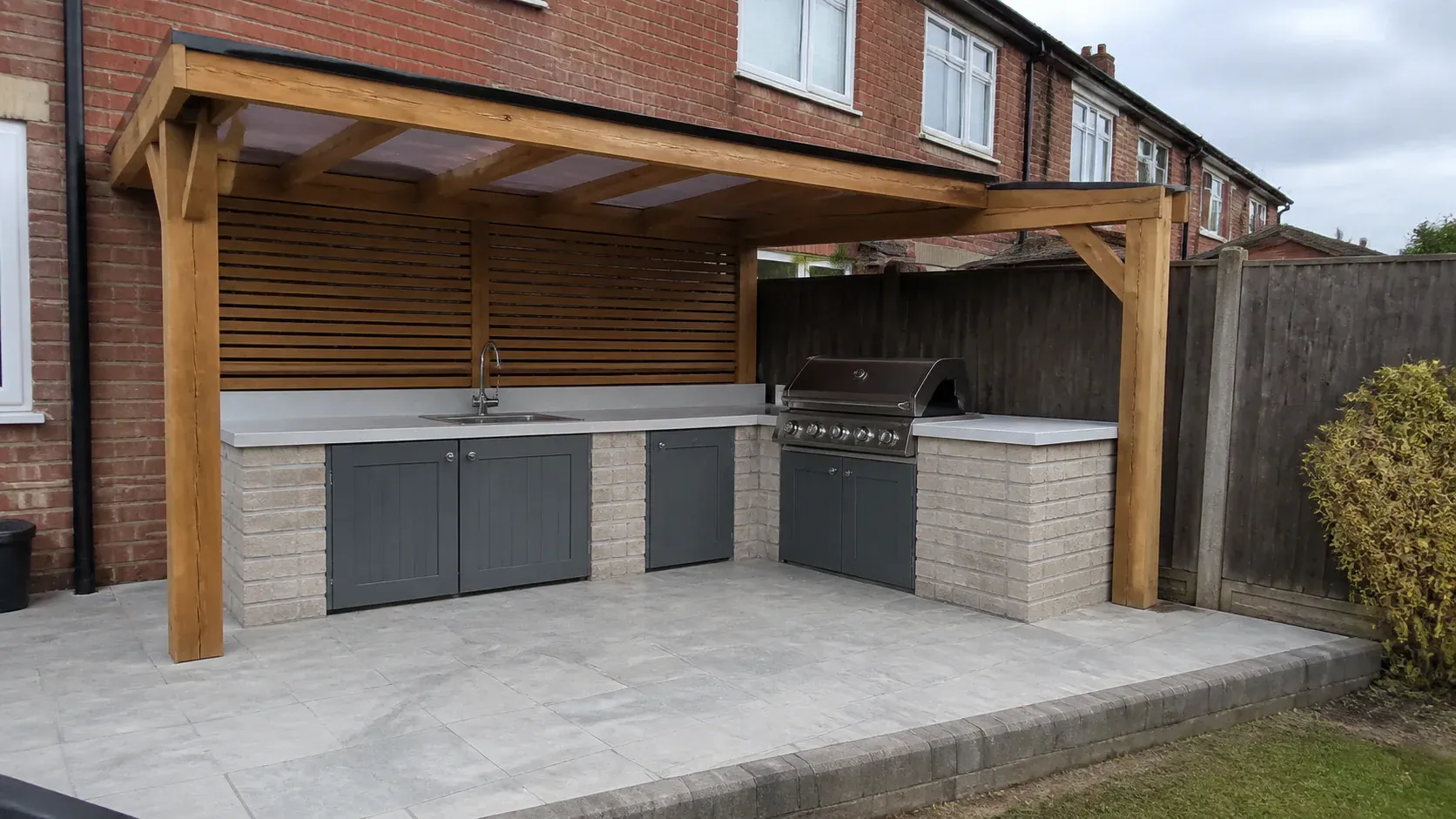 Outdoor garden kitchen built on a neat paved terrace