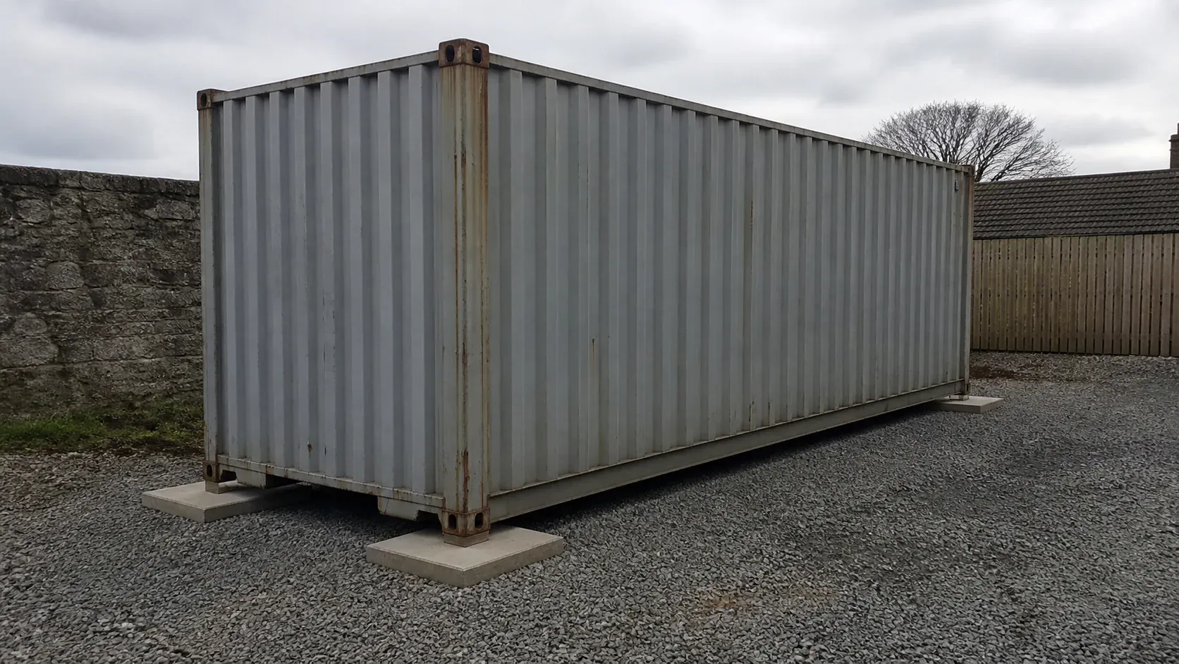 Steel shipping container standing level on prepared support pads