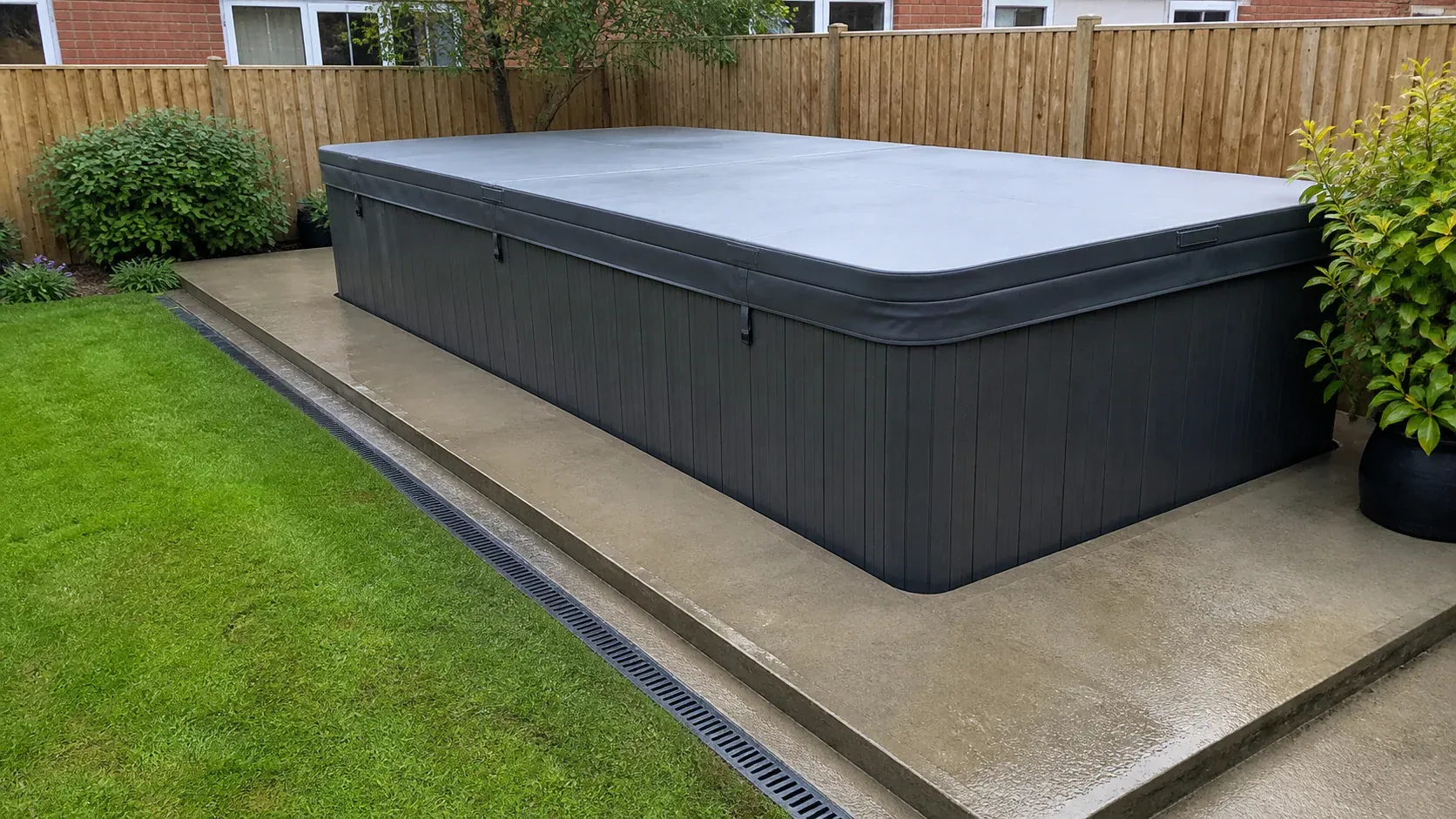 Long outdoor swim spa on a level garden foundation