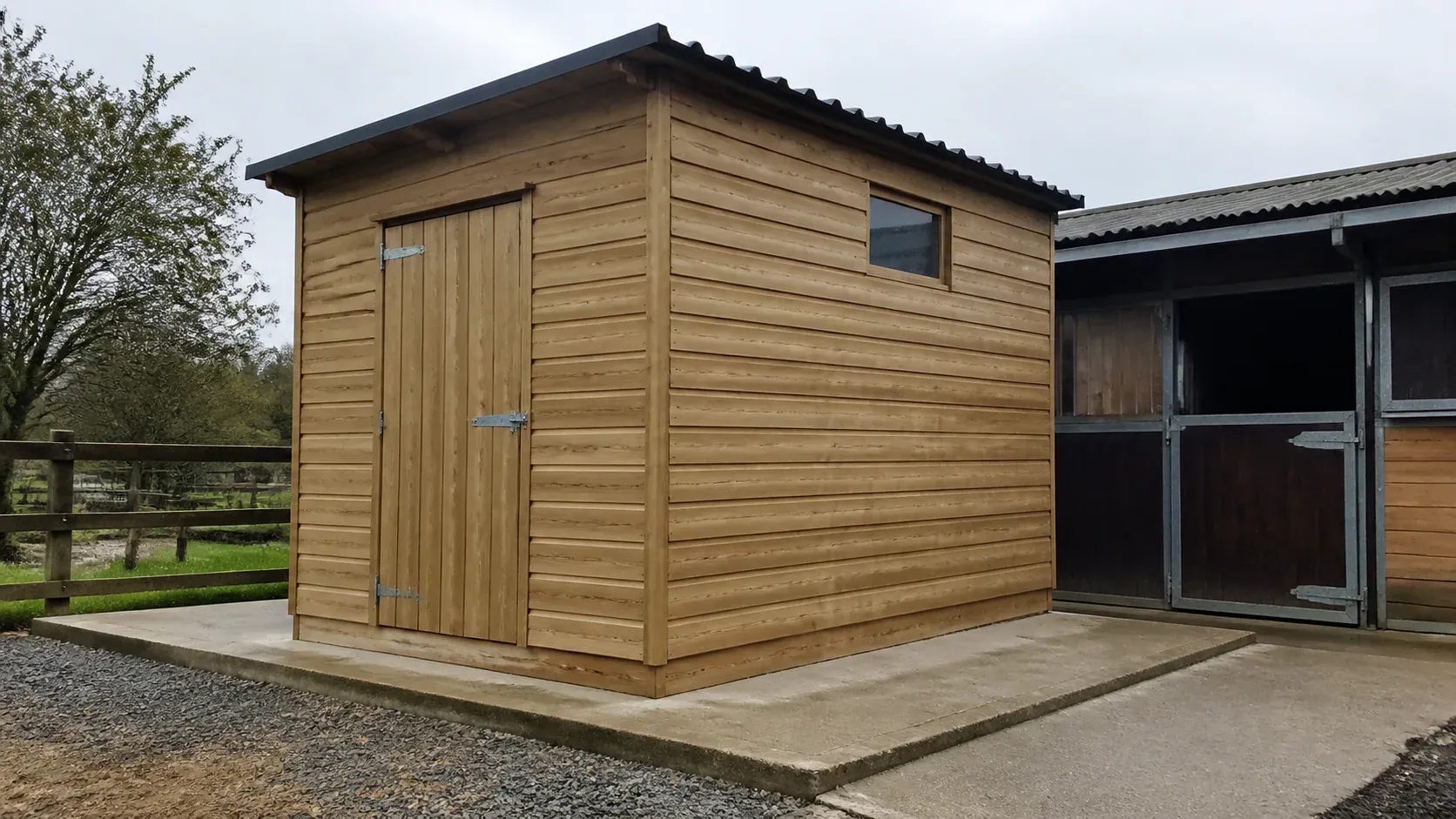 Secure timber tack room beside stables on a dry level base
