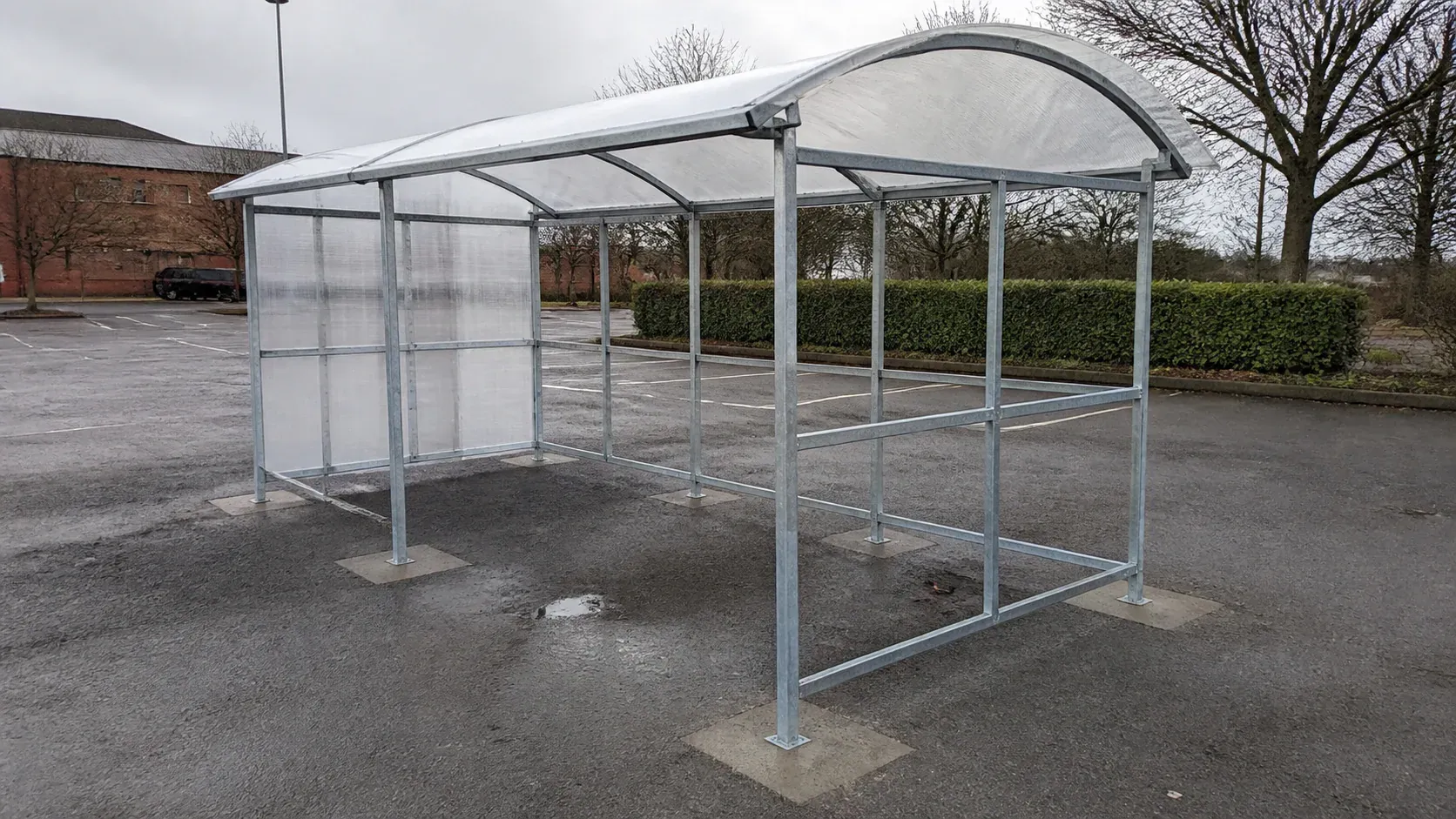 Retail trolley bay shelter securely fixed within a car park
