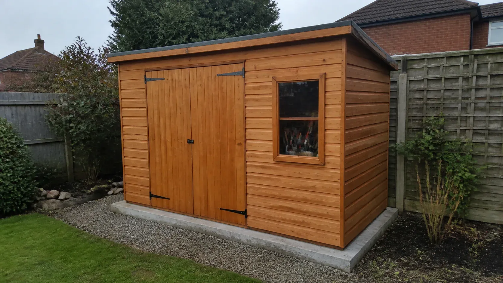 Large timber garden workshop standing on a level foundation